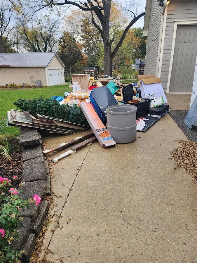 Dumpster being loaded with debris for 3 Yard Dumpster Rental in Oak Bluffs